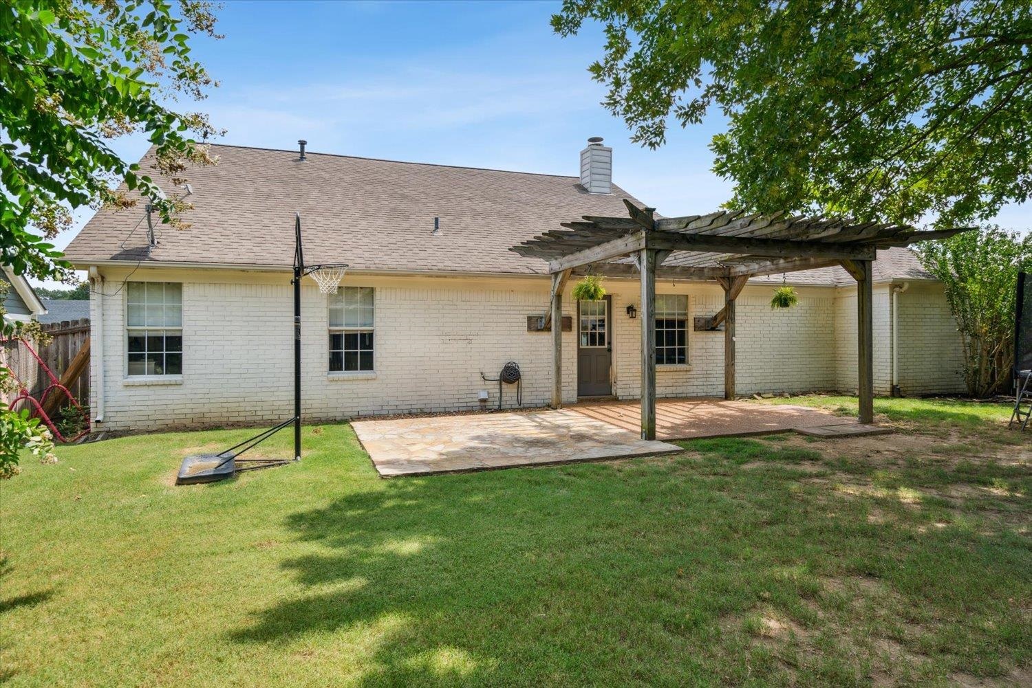 1423 Howling Drive Collierville, TN 38017 - Photo 24 of 28 Rear view of house with a patio area, a lawn, and a pergola
