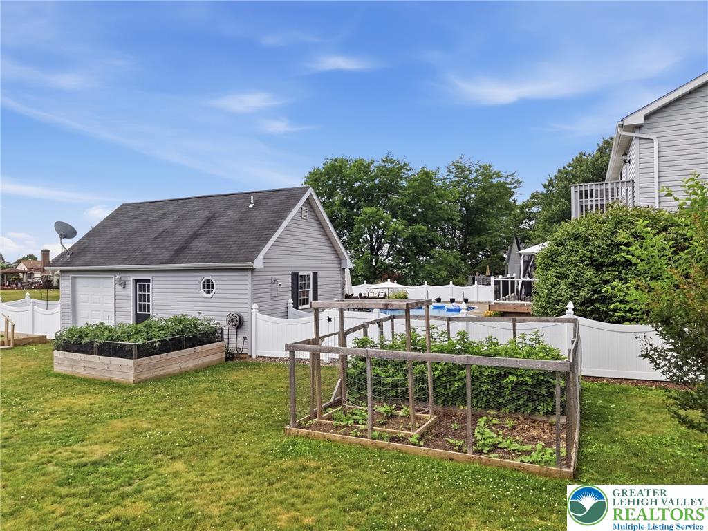 890 Lahr Road Nazareth, PA 18064 - Photo 67 of 71 A private backyard oasis features a detached garage, lush gardens, and a pool.