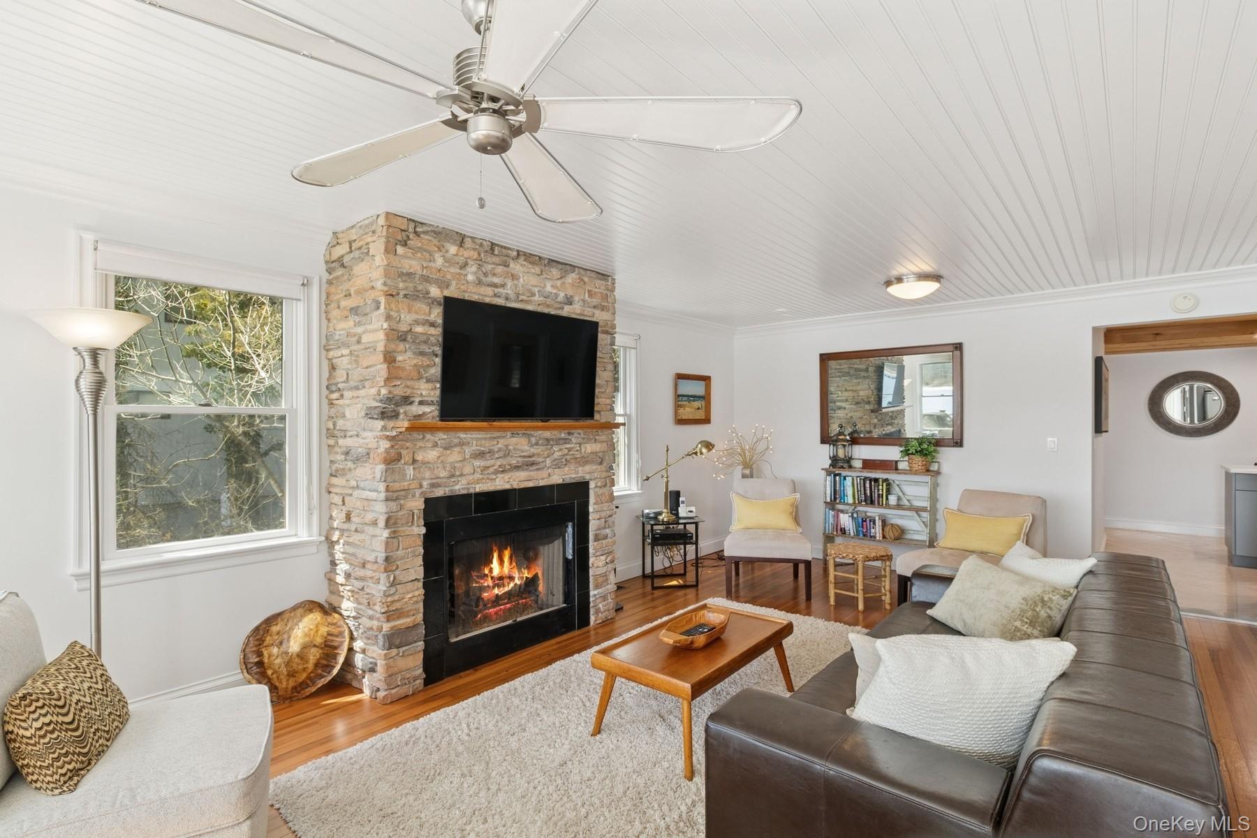 80 Towd Point Road Southampton, NY 11968 - Photo 11 of 30 a living room with furniture a fireplace and a window