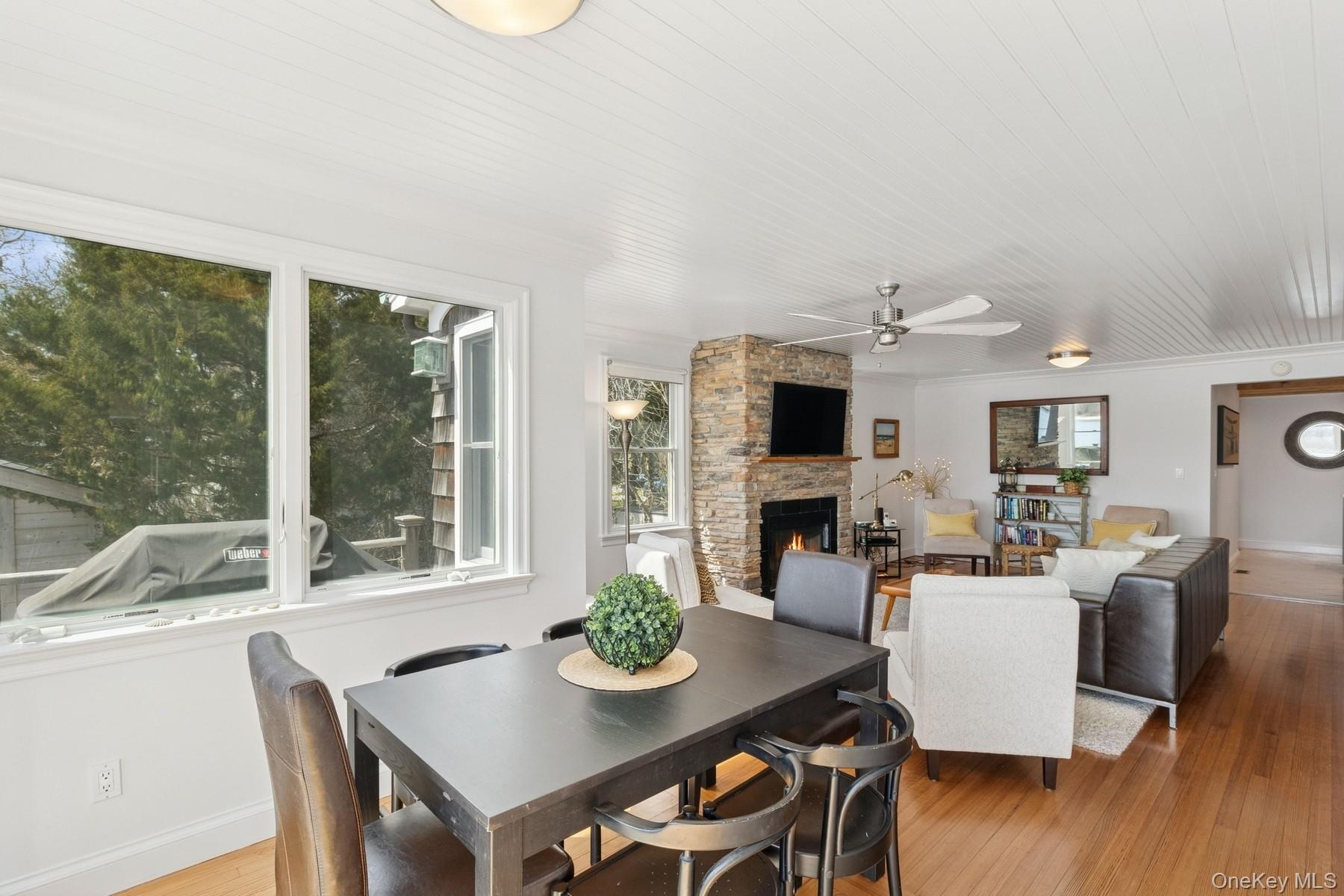 80 Towd Point Road Southampton, NY 11968 - Photo 14 of 30 a view of a dining room with furniture wooden floor and a floor to ceiling window