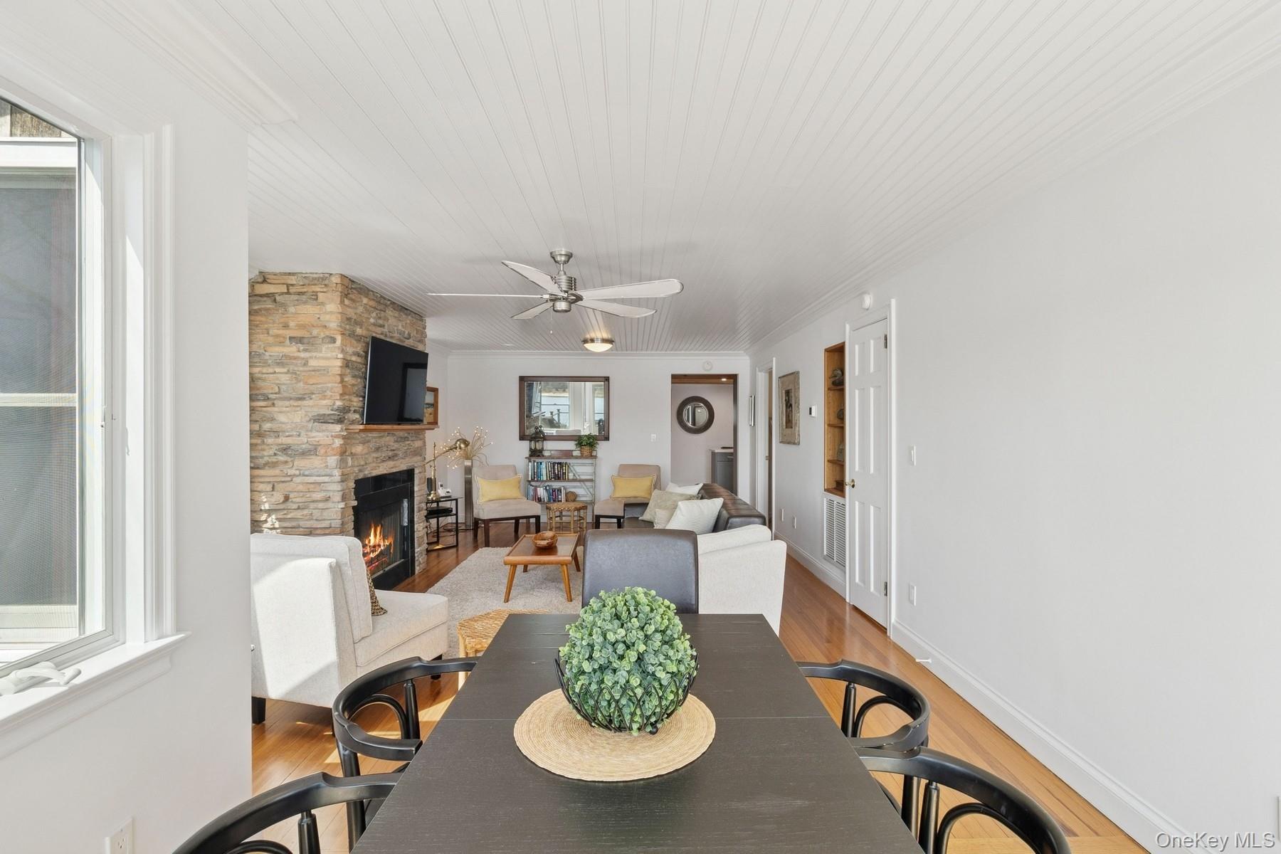 80 Towd Point Road Southampton, NY 11968 - Photo 15 of 30 a living room with furniture a fireplace and a flat screen tv