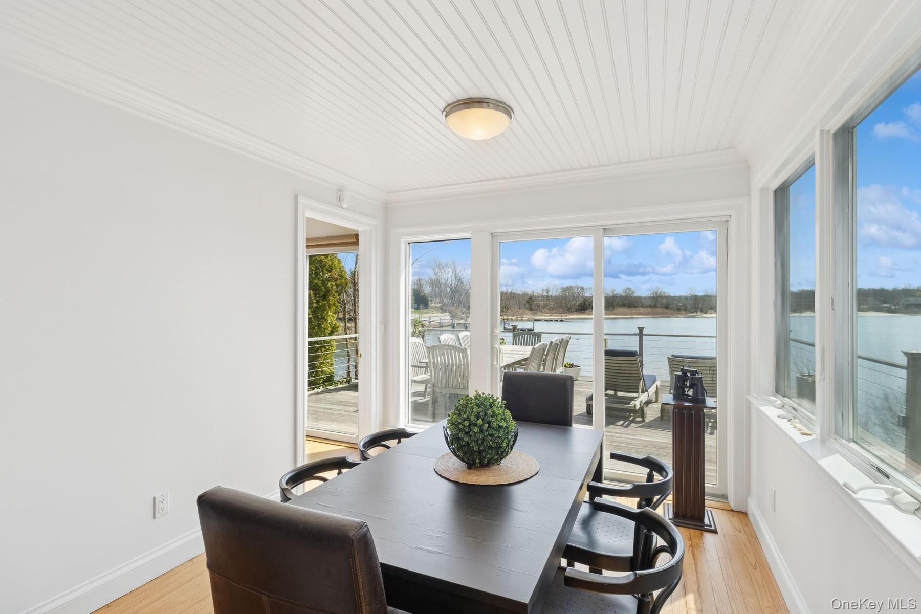 80 Towd Point Road Southampton, NY 11968 - Photo 16 of 30 a view of a dining room with furniture window and outside view