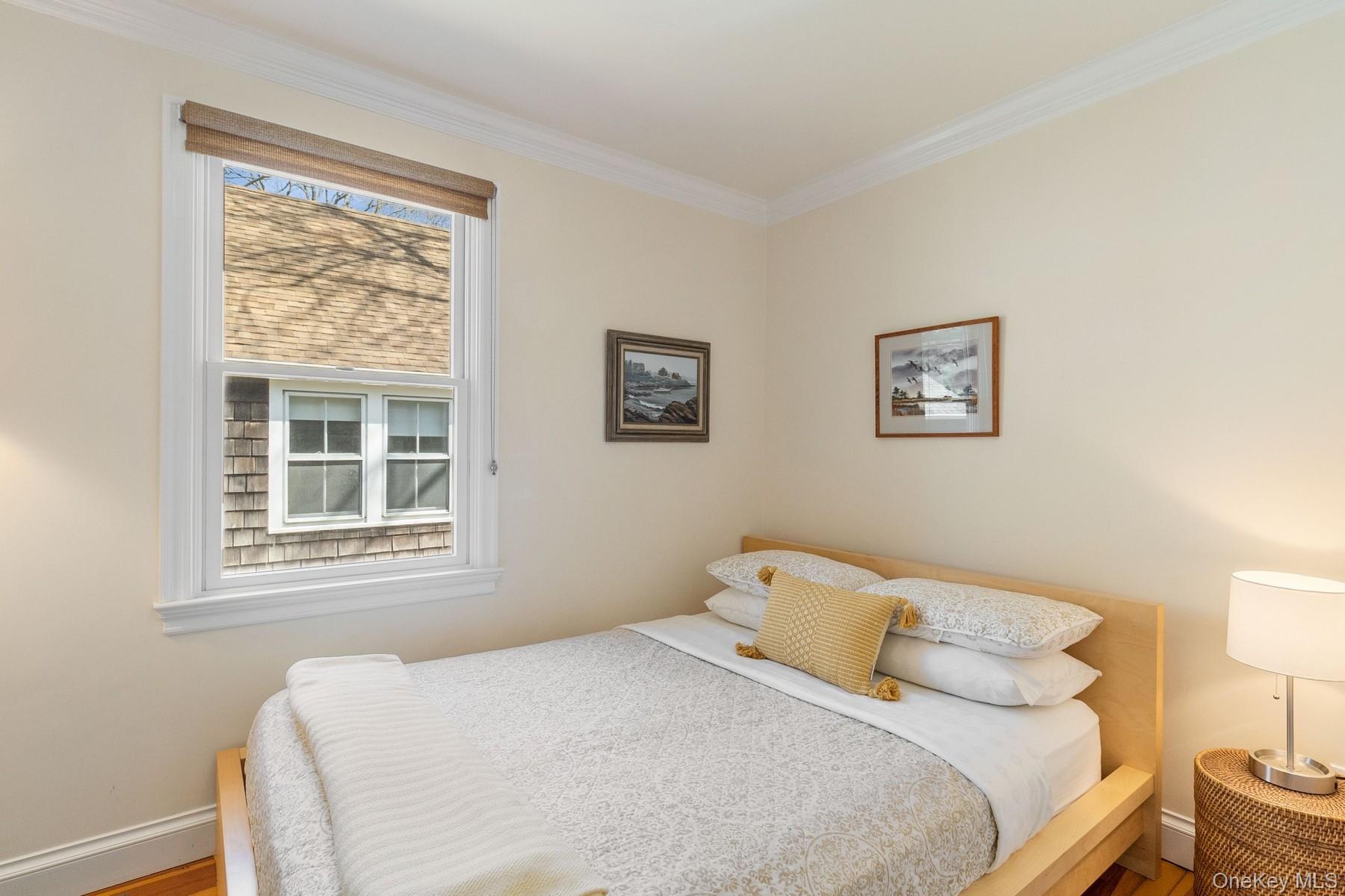 80 Towd Point Road Southampton, NY 11968 - Photo 19 of 30 a bedroom with a bed and a window