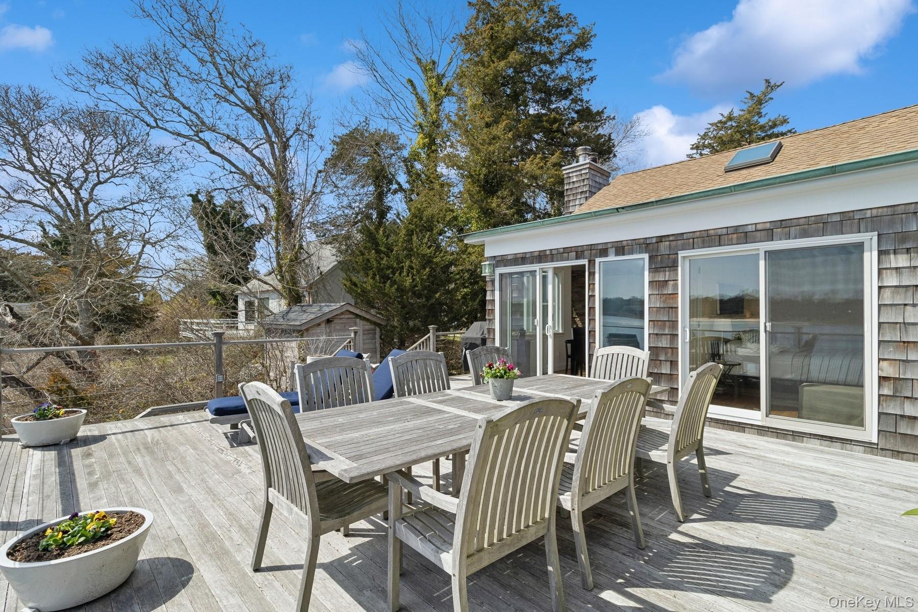 80 Towd Point Road Southampton, NY 11968 - Photo 26 of 30 a view of a patio with table and chairs and potted plants