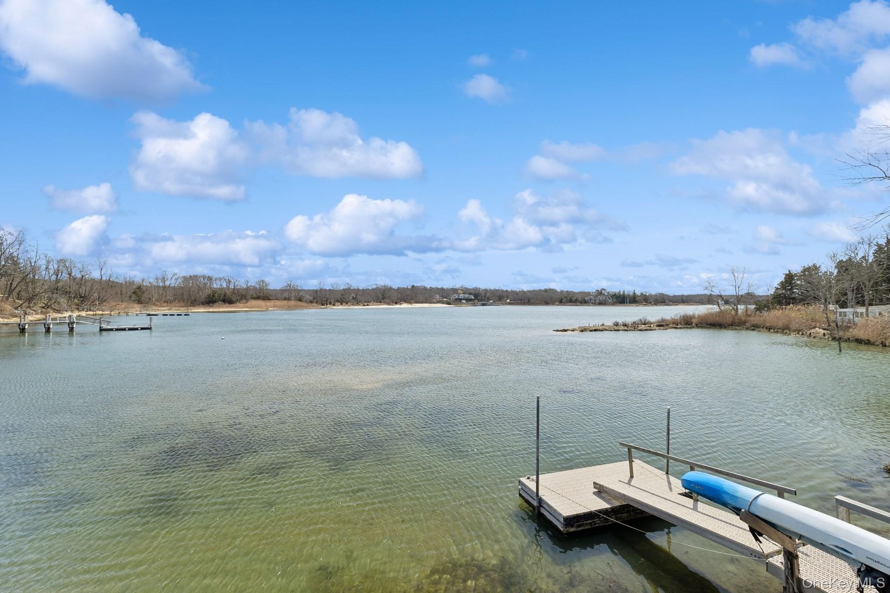 80 Towd Point Road Southampton, NY 11968 - Photo 27 of 30 a view of a lake with houses in the back