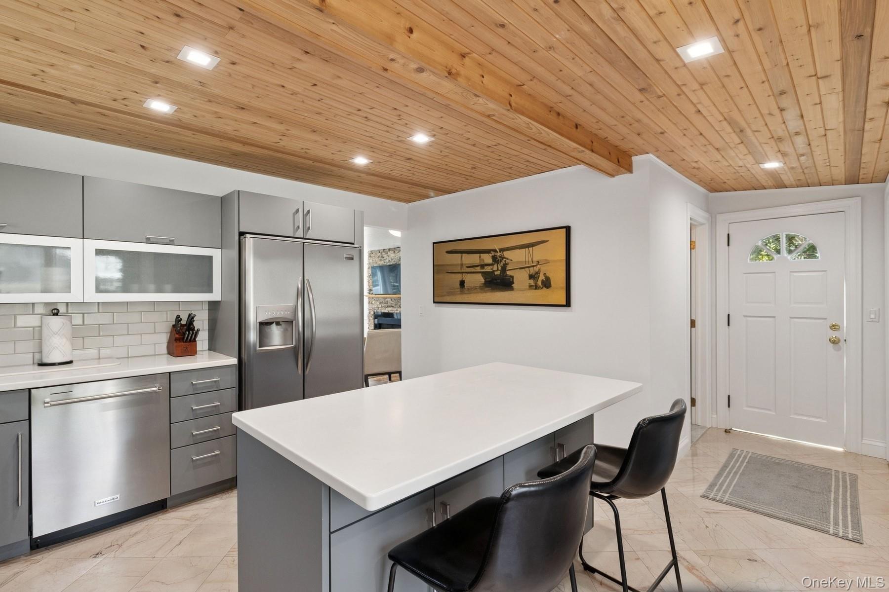 80 Towd Point Road Southampton, NY 11968 - Photo 6 of 30 a kitchen with stainless steel appliances a refrigerator a stove a sink dishwasher with a dining table and chairs