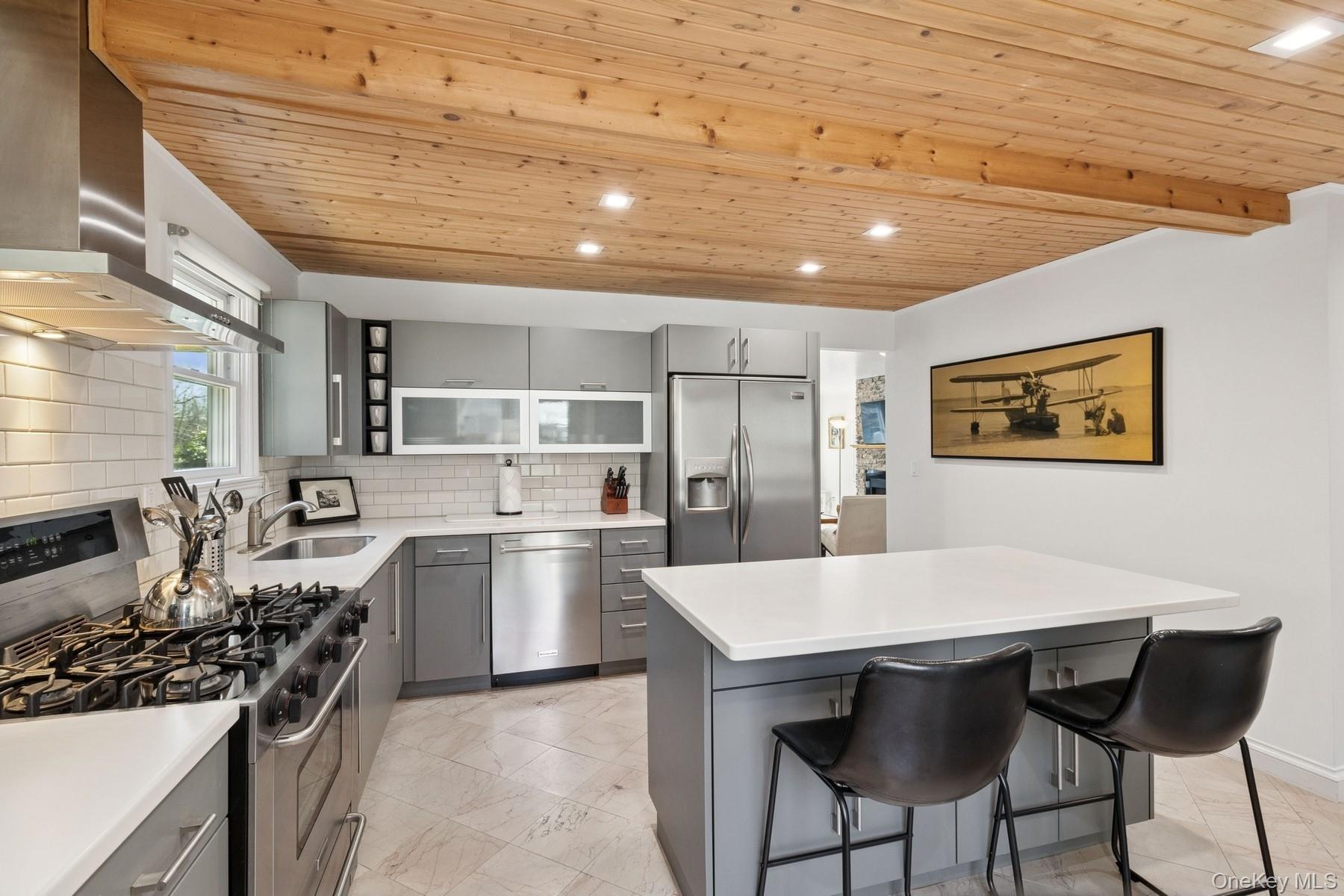 80 Towd Point Road Southampton, NY 11968 - Photo 7 of 30 a kitchen with a table and chairs in it