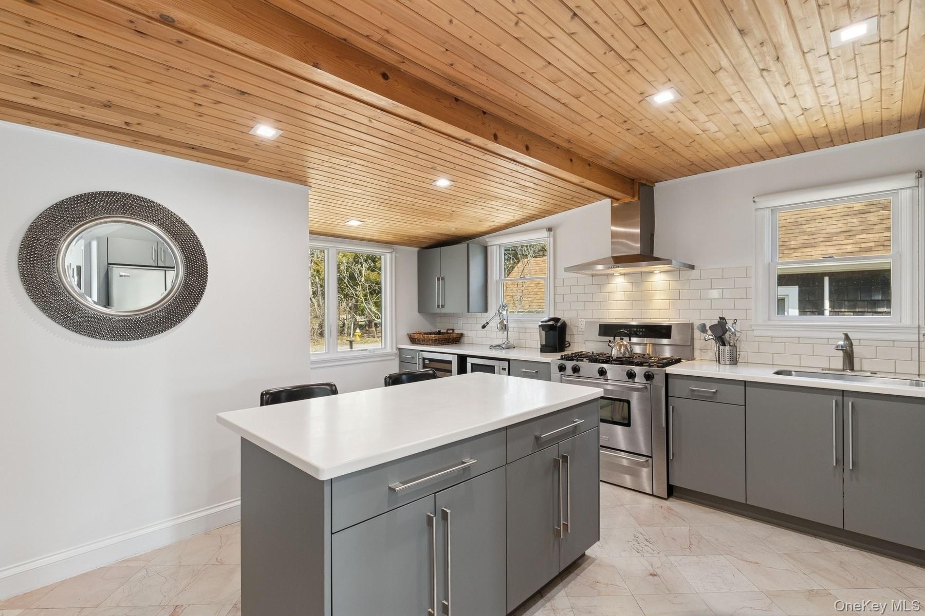 80 Towd Point Road Southampton, NY 11968 - Photo 8 of 30 a kitchen with a sink a stove and cabinets