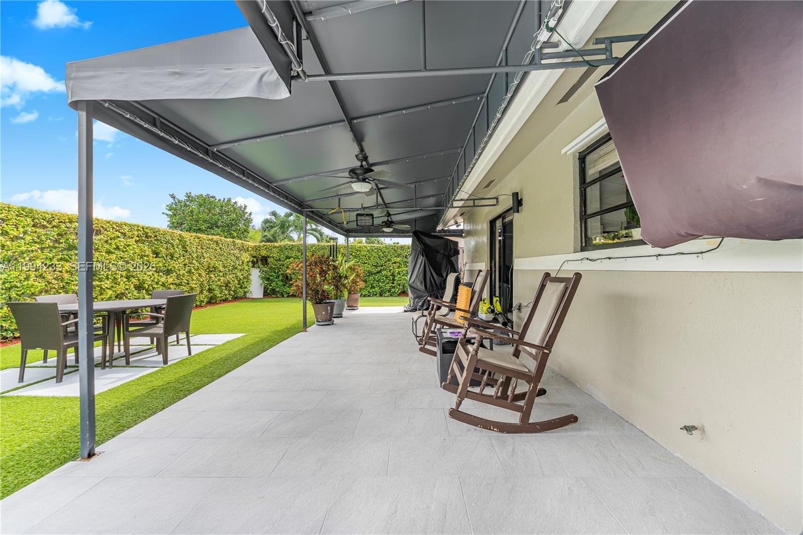 2385 Southwest 131st Place Miami, FL 33175 - Photo 28 of 39 a view of a patio with a table and chairs