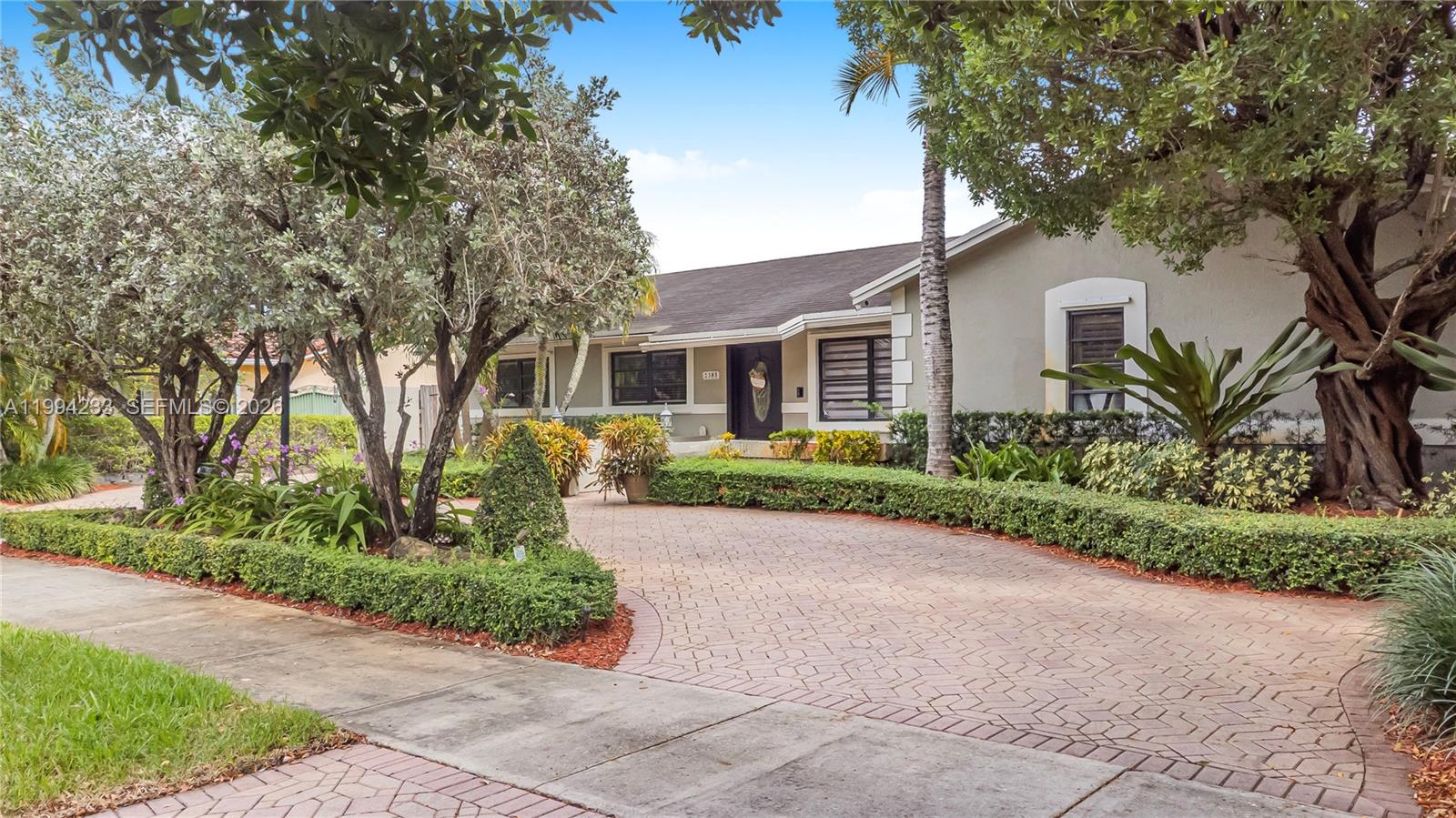 2385 Southwest 131st Place Miami, FL 33175 - Photo 30 of 39 a front view of a house with a garden