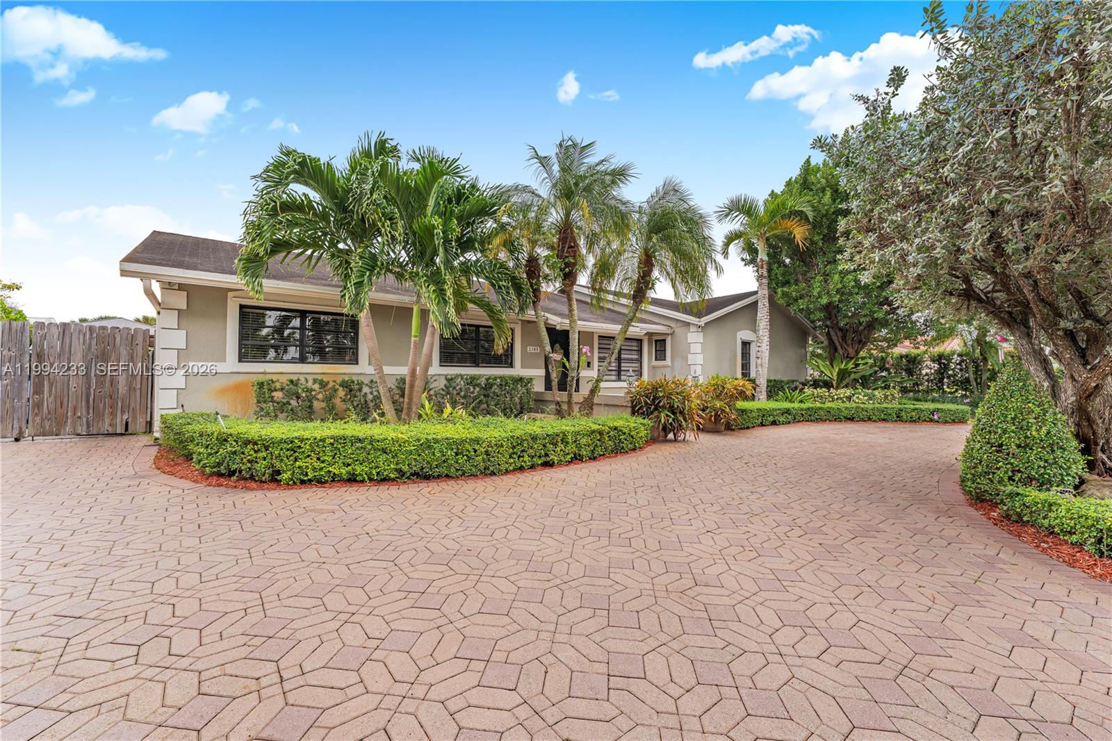 2385 Southwest 131st Place Miami, FL 33175 - Photo 31 of 39 a front view of a house with a yard and potted plants