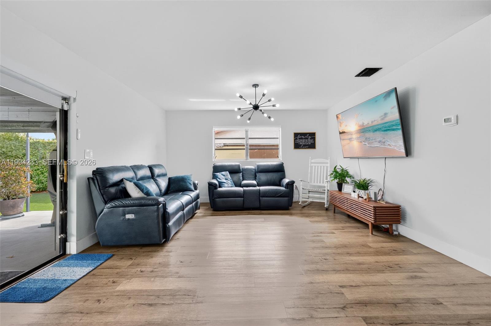 2385 Southwest 131st Place Miami, FL 33175 - Photo 7 of 39 a living room with furniture and a large window