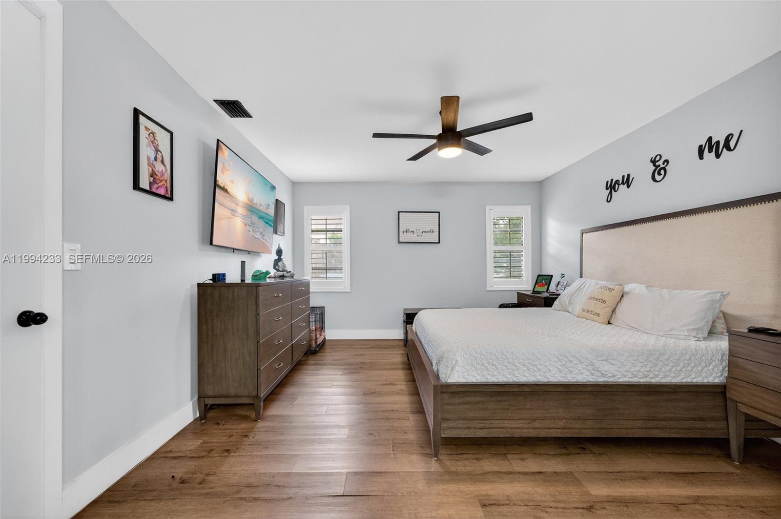 2385 Southwest 131st Place Miami, FL 33175 - Photo 9 of 39 a spacious bedroom with a bed and a flat screen tv