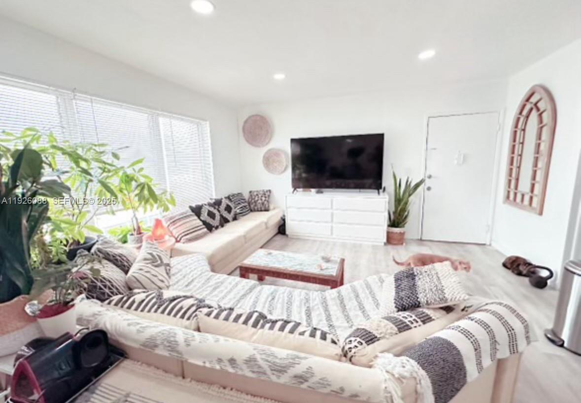 324 Surfside Boulevard, Unit 7 Surfside, FL 33154 - Photo 12 of 14 a living room with furniture and a flat screen tv