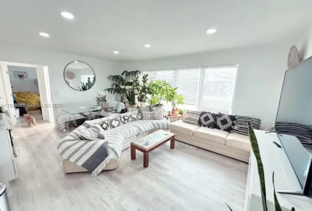 a living room with furniture rug and window