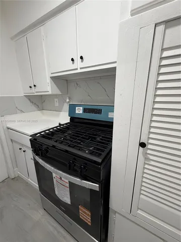 a stove top oven sitting inside of a kitchen