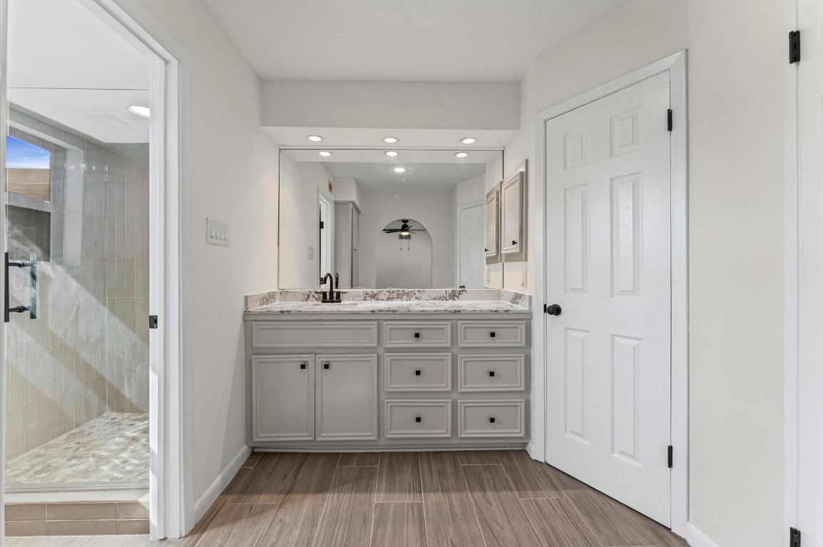 5634 Jason Street Houston, TX 77096 - Photo 18 of 25 a bathroom with a granite countertop sink mirror and shower