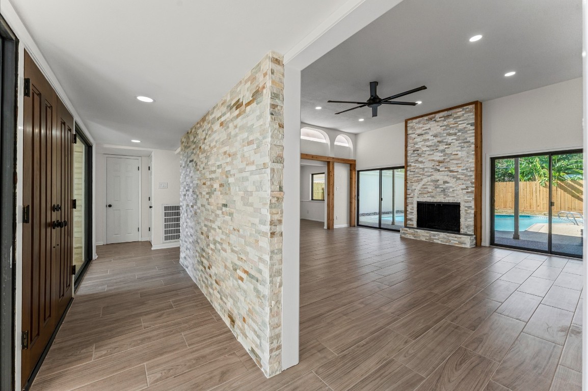 5634 Jason Street Houston, TX 77096 - Photo 5 of 25 wooden floor in an empty room with a fireplace