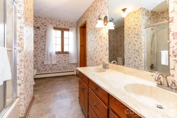 a bathroom with a shower and a sink
