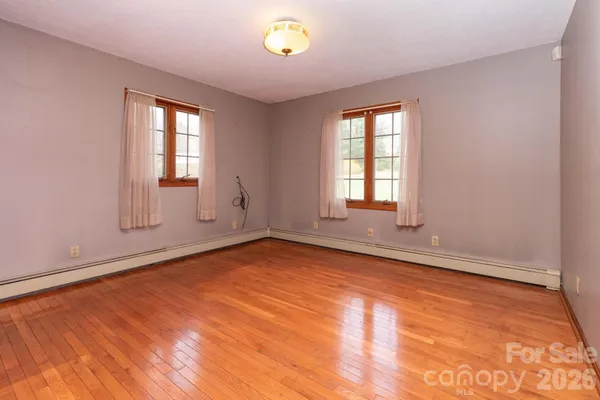 view of a room with wooden floor and windows