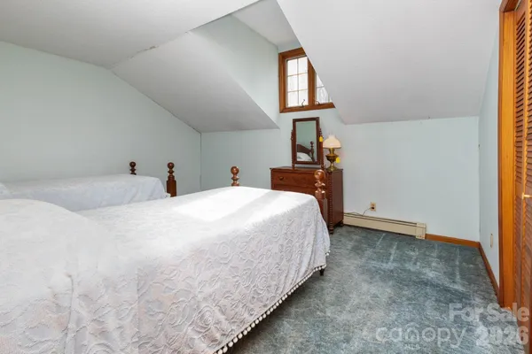 a spacious bathroom with a tub sink and mirror