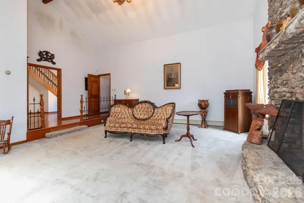 a view of a kitchen with furniture and wooden floor