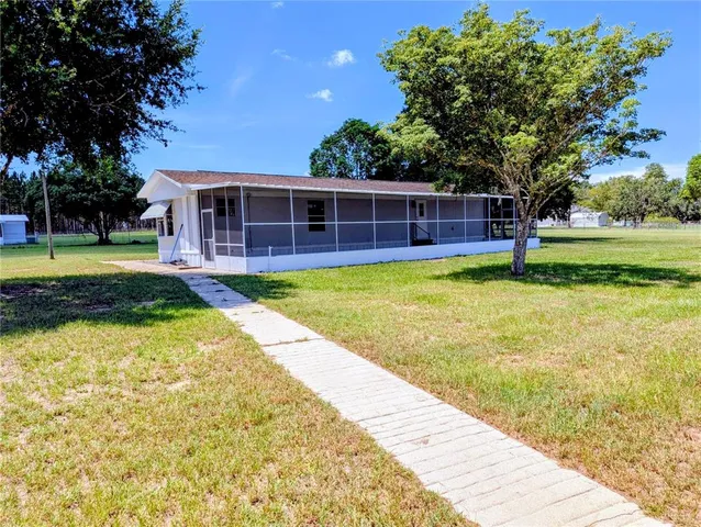 a view of a house with swimming pool and yard with green space