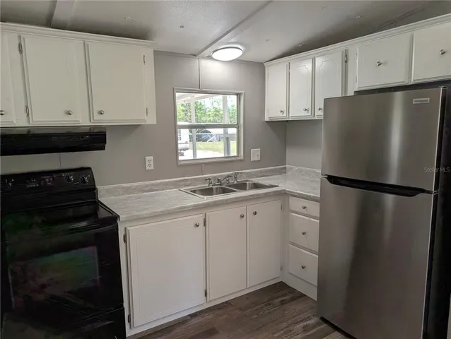 a kitchen with a refrigerator stove and sink