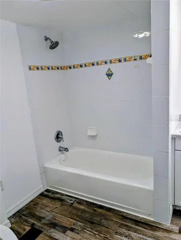 a bathroom with a bathtub and a window