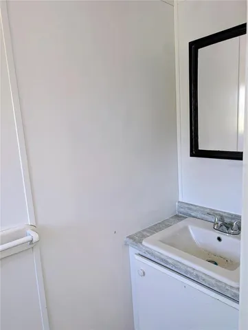 a bathroom with a sink and mirror