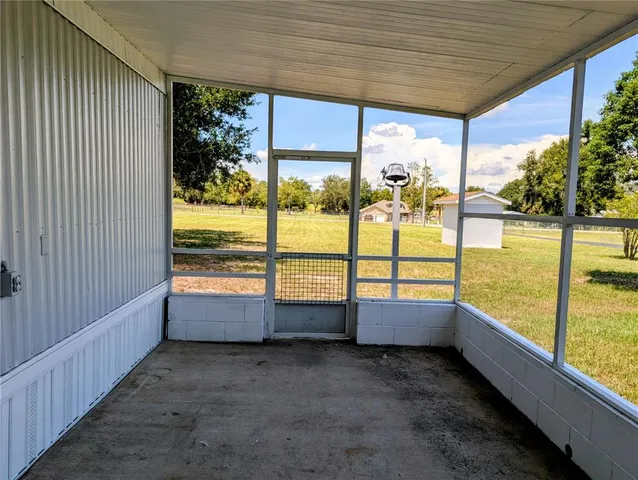 a view of an empty room with large windows