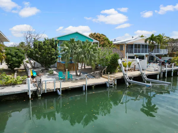 a view of outdoor dining space with a patio and swimming pool