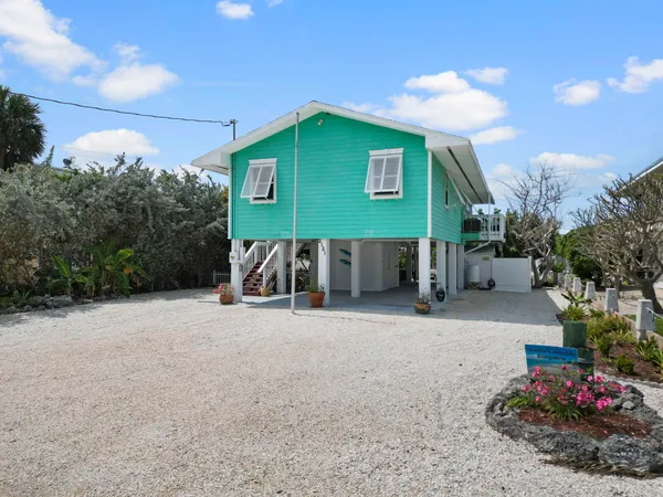 an aerial view of a city with lots of residential buildings lake and ocean view