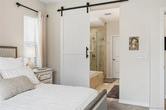 a bedroom with a bed and a shower