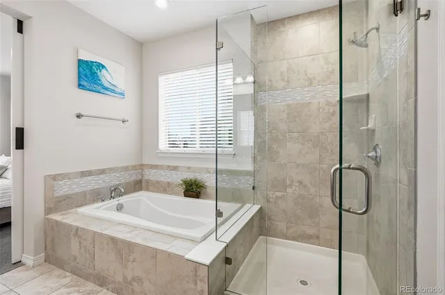 a white bath tub sitting next to a shower