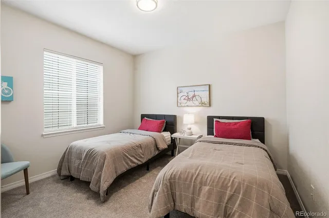 a bedroom with two beds and a window