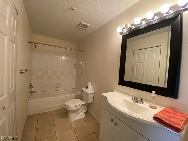 a bathroom with a sink a toilet and shower a mirror