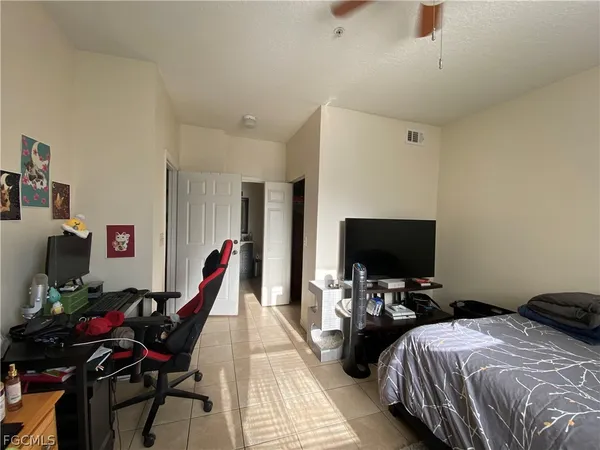 a bedroom with bed and tv