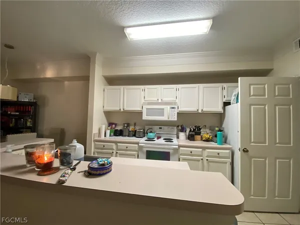 a kitchen with a sink a stove and cabinets
