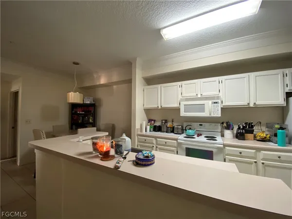 a kitchen with stainless steel appliances a sink stove and cabinets
