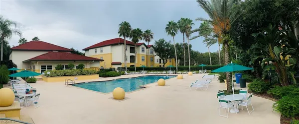 a view of a house with swimming pool and sitting area
