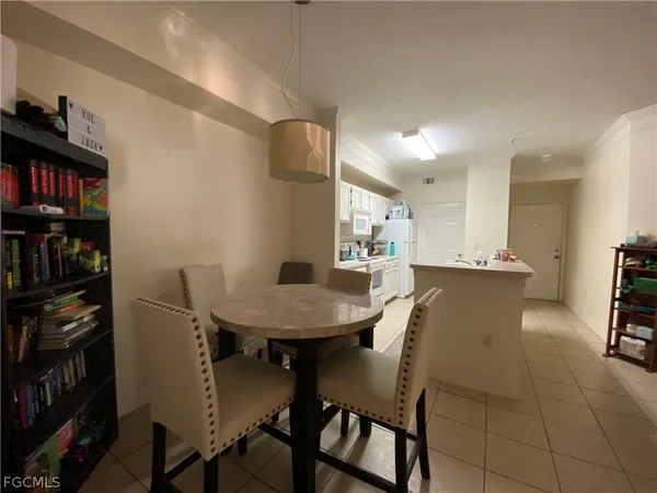 a view of a dining room with furniture and a book shelf