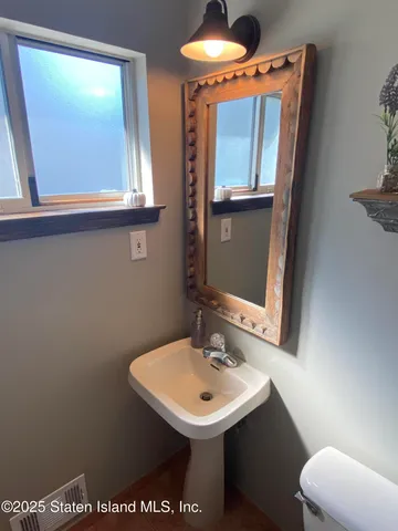 a kitchen with stainless steel appliances granite countertop a dining table chairs microwave and refrigerator