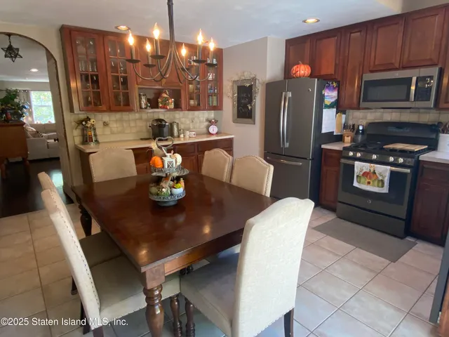 a view of a dining room with furniture and chandelier