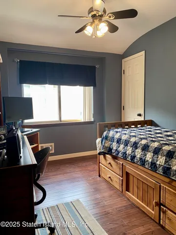a bathroom with a sink mirror and shower