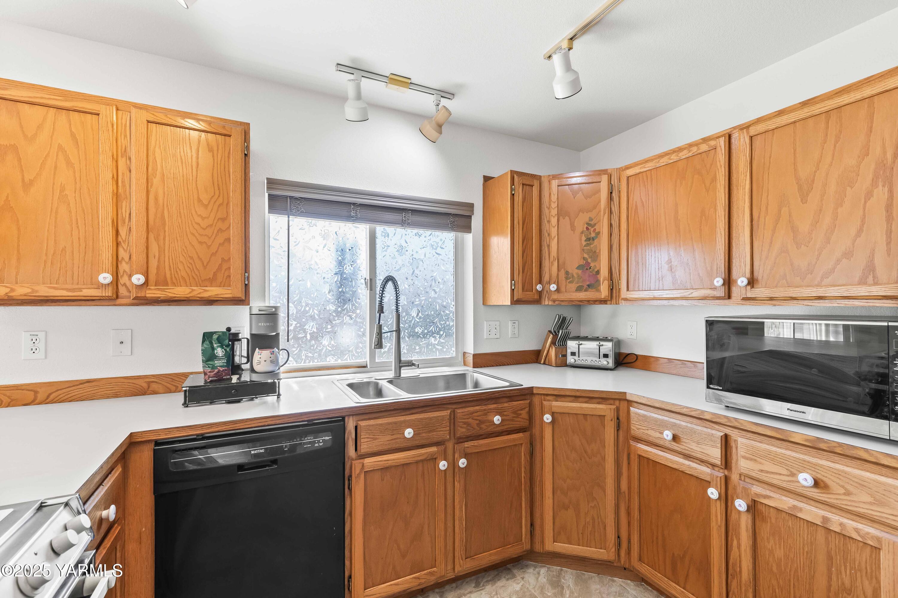 6508 Terry Avenue Yakima, WA 98908 - Photo 11 of 24 a kitchen with a sink a window and cabinets