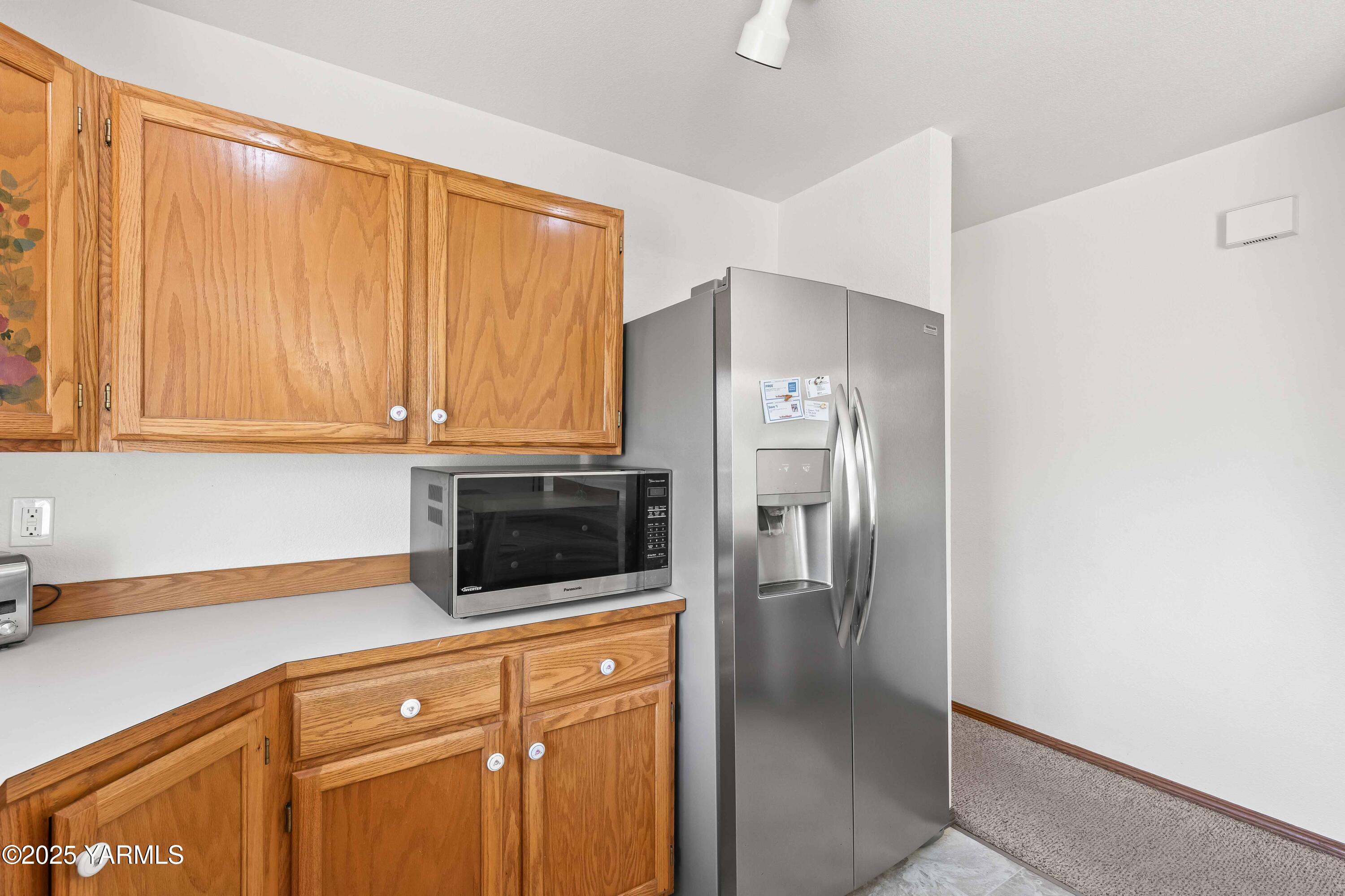 6508 Terry Avenue Yakima, WA 98908 - Photo 12 of 24 a kitchen with stainless steel appliances a refrigerator and cabinets