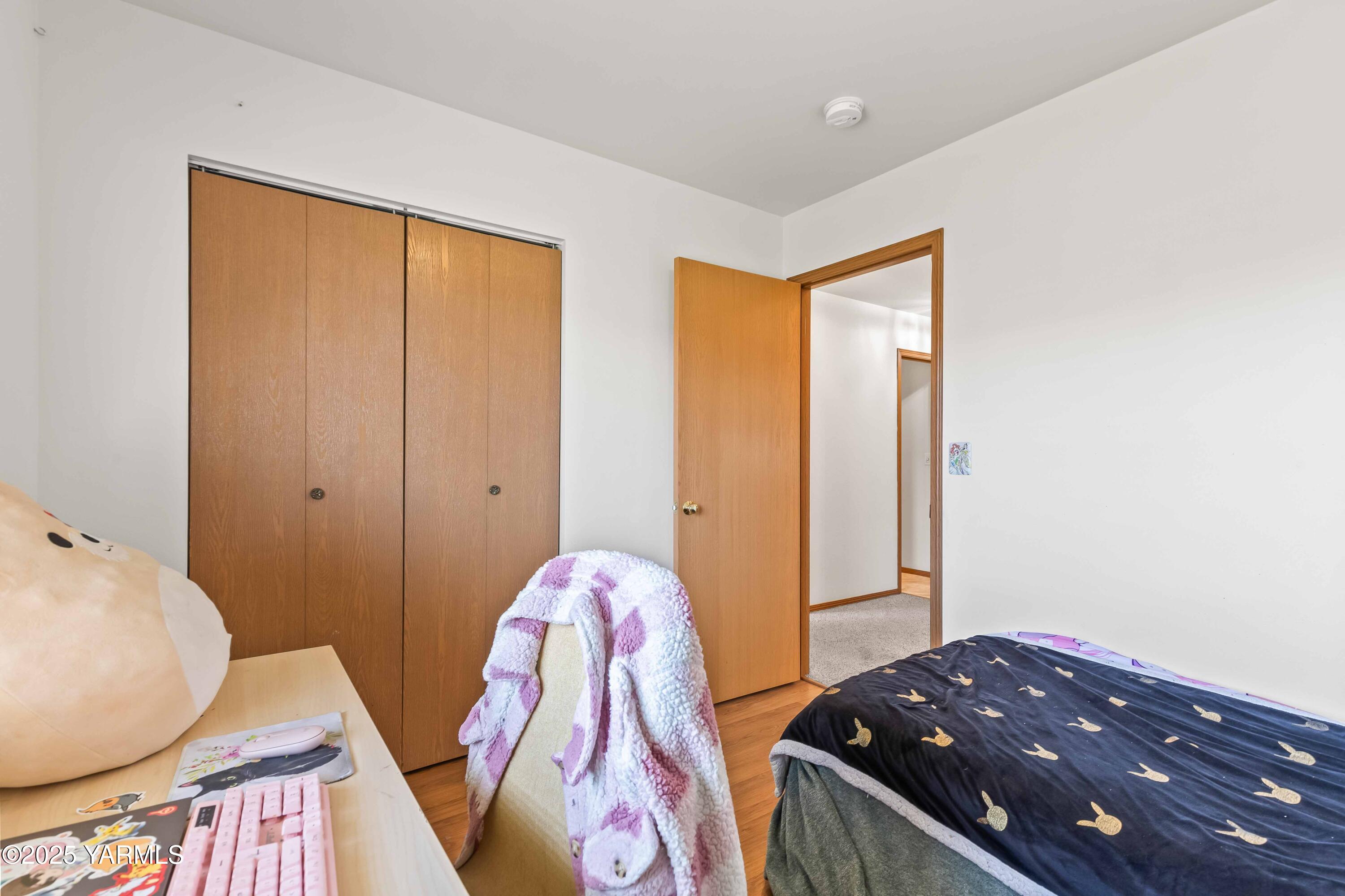 6508 Terry Avenue Yakima, WA 98908 - Photo 16 of 24 a bedroom with a bed and wooden floor