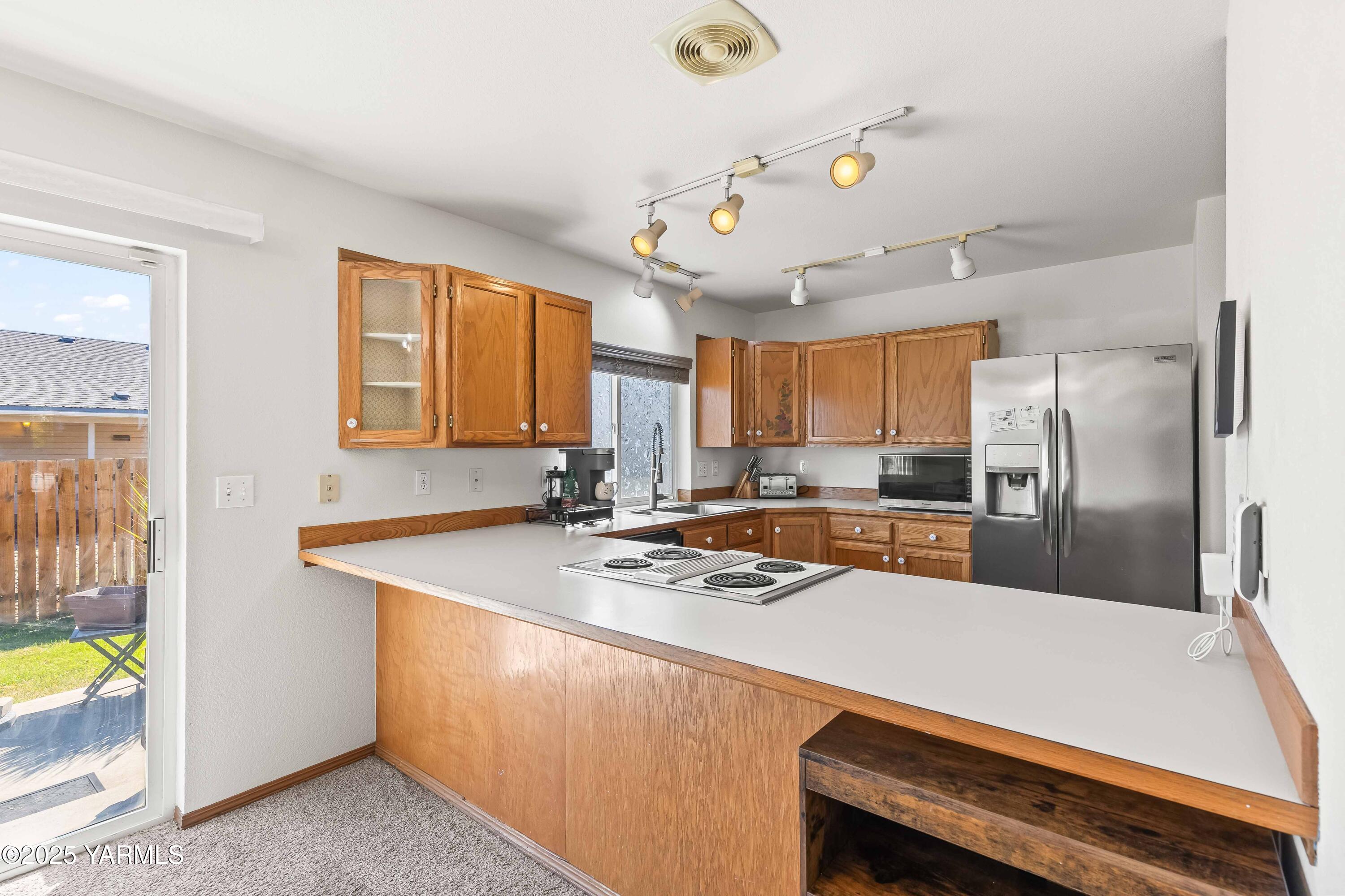 6508 Terry Avenue Yakima, WA 98908 - Photo 7 of 24 a kitchen with stainless steel appliances granite countertop a sink a stove and refrigerator