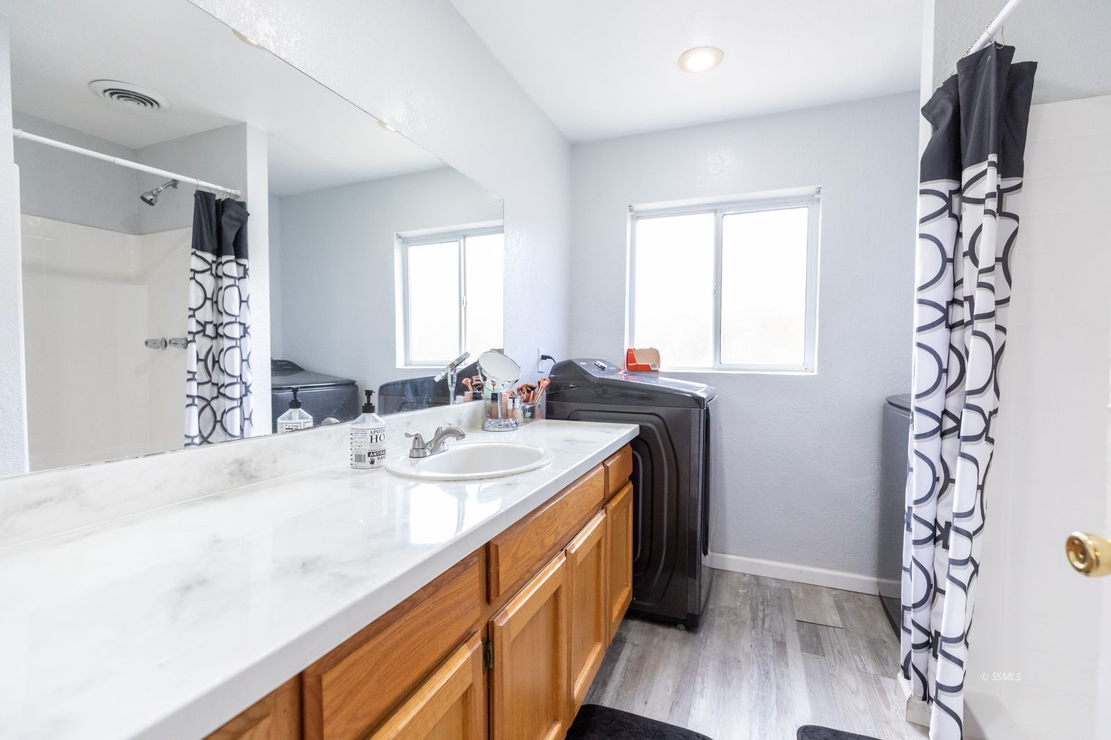 234 Panamint Avenue Ridgecrest, CA 93555 - Photo 22 of 25 a bathroom with a sink a mirror and a shower